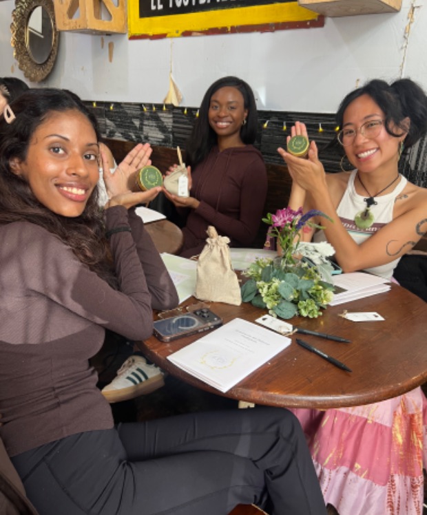 Attendees holding handmade keepsakes at an EVE workshop